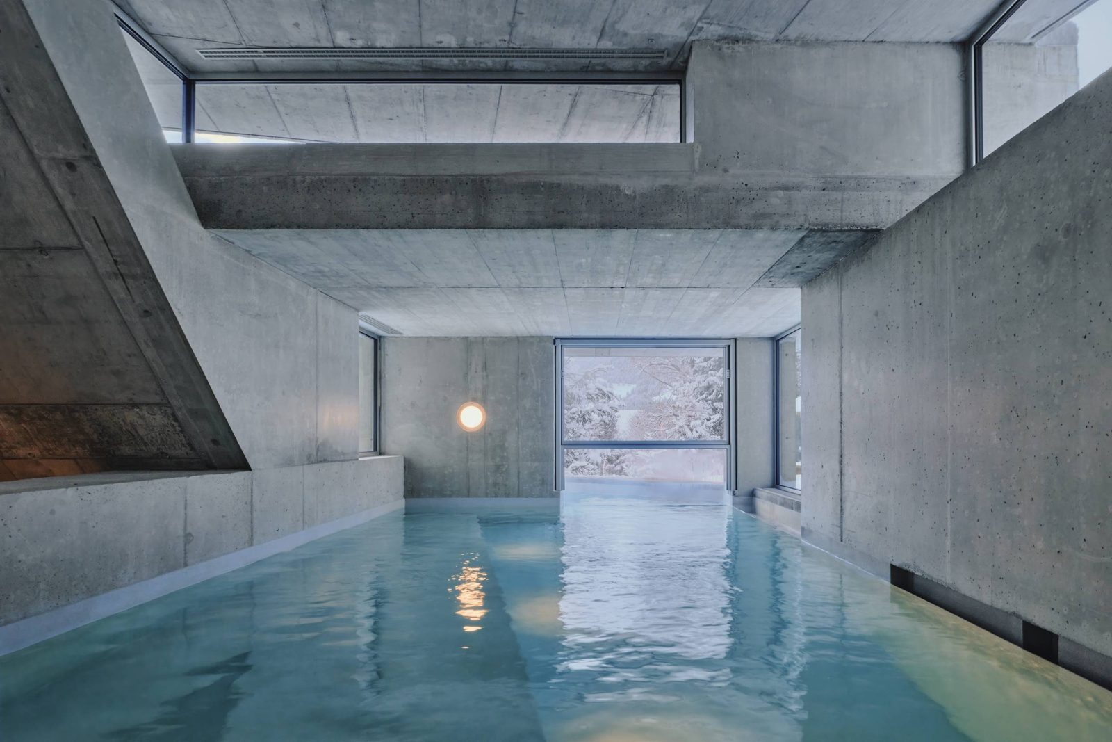 The indoor pool between raw concrete walls