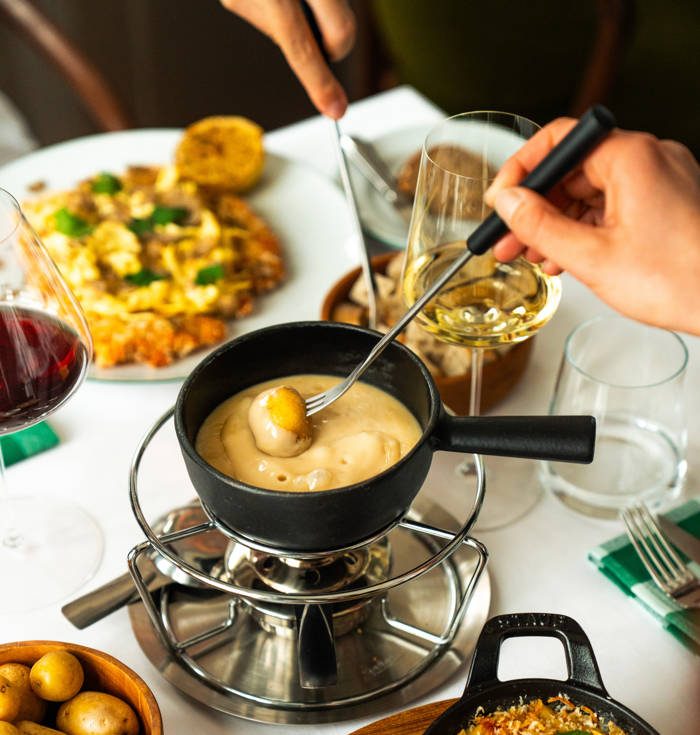 Cheese fondue on its burner